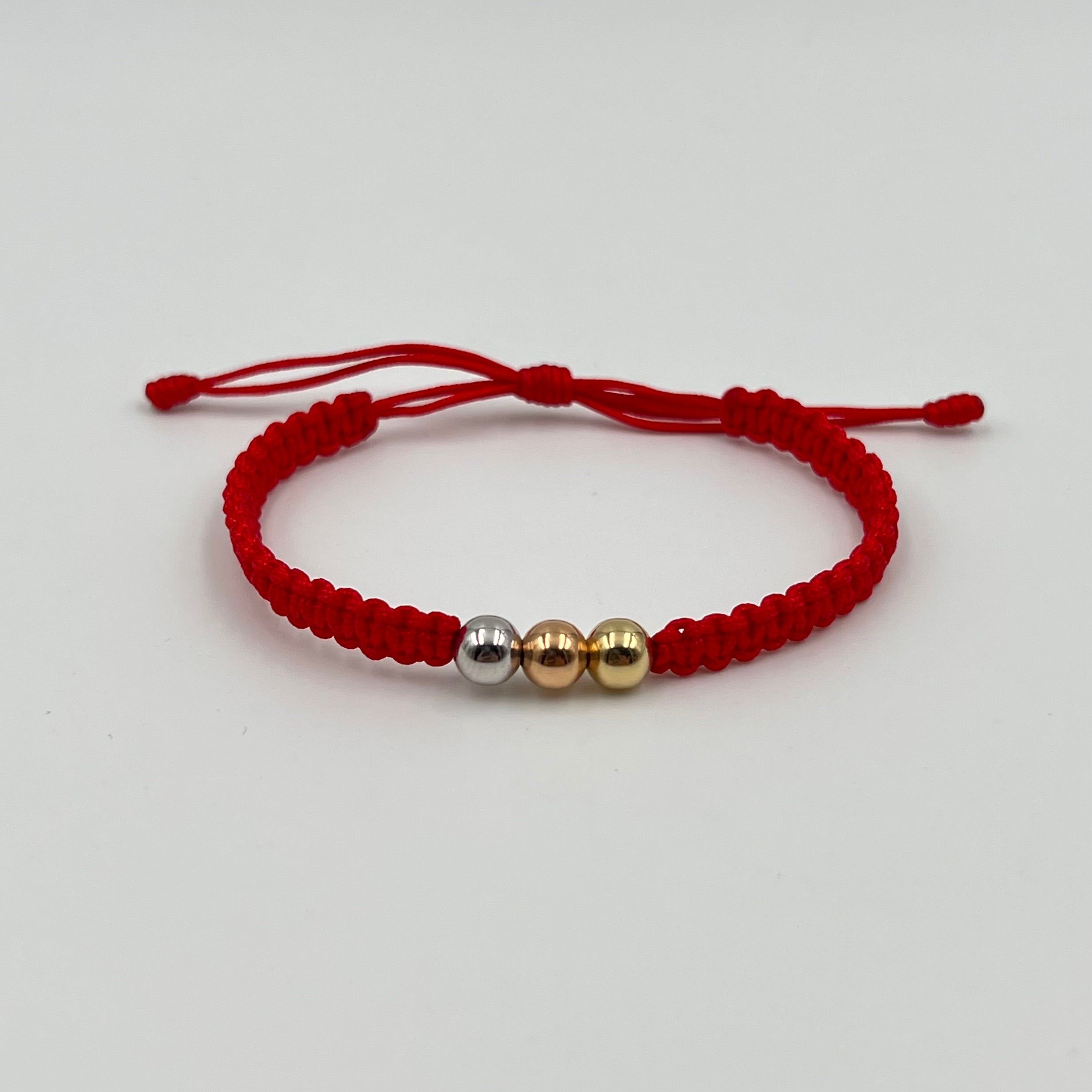 PULSERA TEJIDA ROJA / TRES OROS / BOLA LISA 6MM